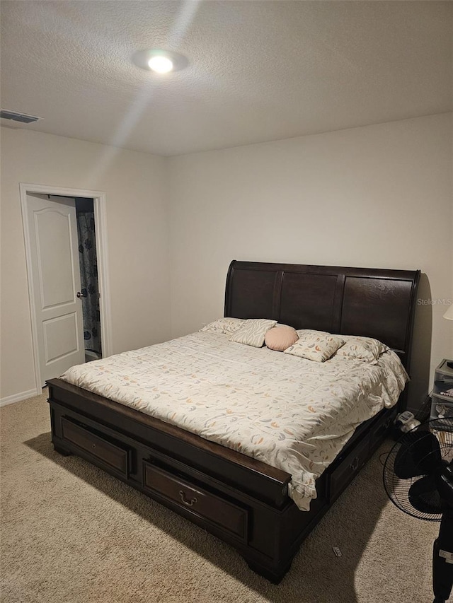 carpeted bedroom featuring a textured ceiling