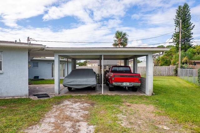 view of parking / parking lot with a yard and a carport