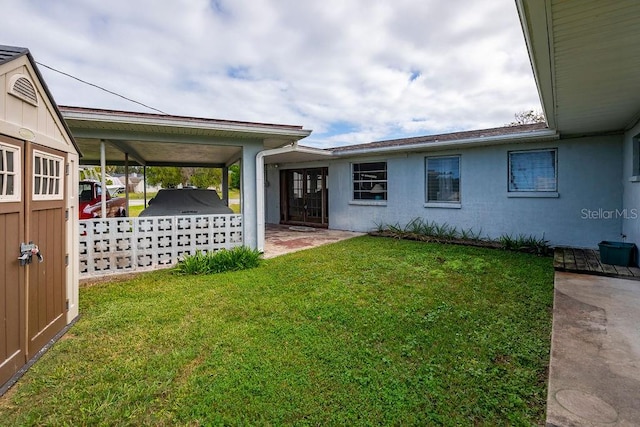 exterior space with a carport and a front yard