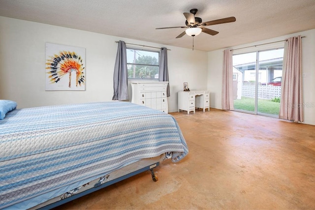 bedroom featuring a textured ceiling, access to outside, ceiling fan, and concrete flooring