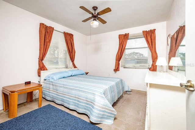 tiled bedroom featuring ceiling fan