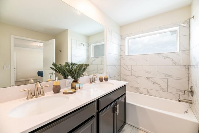 bathroom featuring vanity and tiled shower / bath