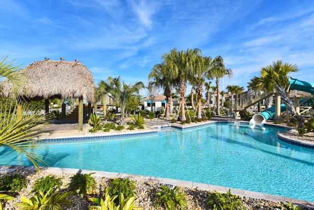 view of swimming pool with a water slide and a gazebo