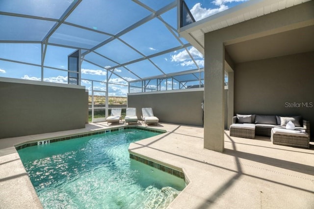 view of swimming pool featuring outdoor lounge area, glass enclosure, and a patio