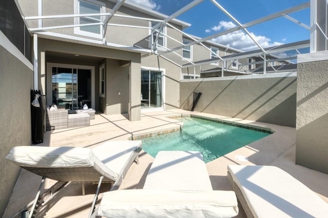 view of swimming pool featuring glass enclosure and a patio area