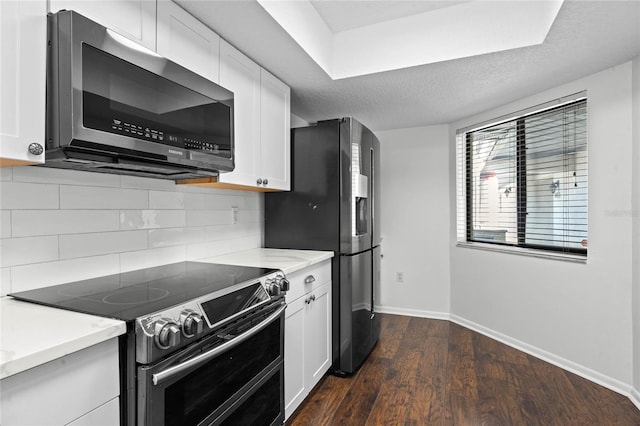 kitchen featuring white cabinetry, appliances with stainless steel finishes, dark hardwood / wood-style floors, a textured ceiling, and decorative backsplash