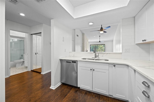 kitchen featuring dark hardwood / wood-style flooring, light stone countertops, sink, white cabinets, and dishwasher