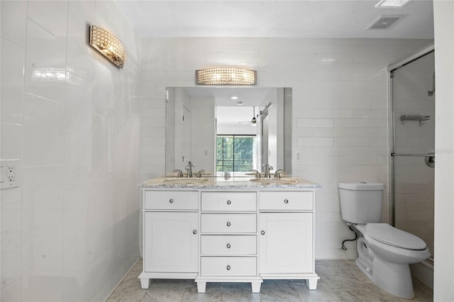 bathroom with walk in shower, vanity, a textured ceiling, and toilet