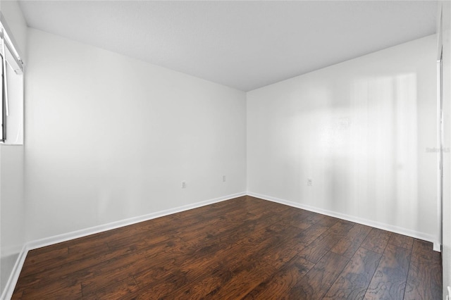 empty room with hardwood / wood-style flooring