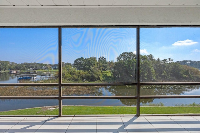 unfurnished sunroom with a water view