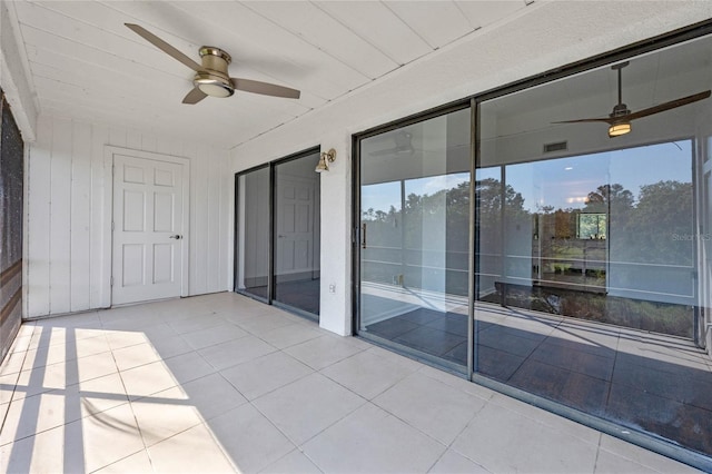 interior space with ceiling fan