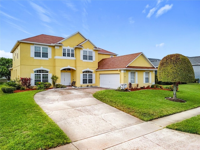 view of front of home featuring a garage and a front lawn