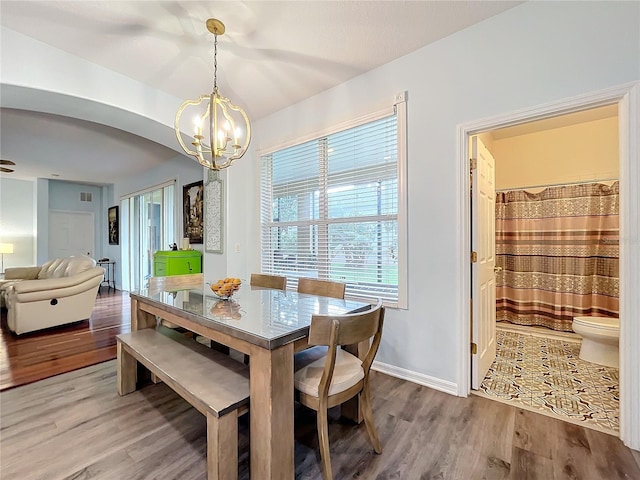 dining room featuring hardwood / wood-style flooring and a chandelier