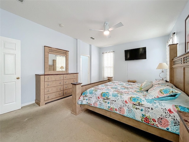 bedroom featuring ceiling fan and light colored carpet