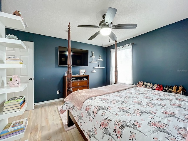 bedroom featuring a textured ceiling, ceiling fan, and light hardwood / wood-style flooring