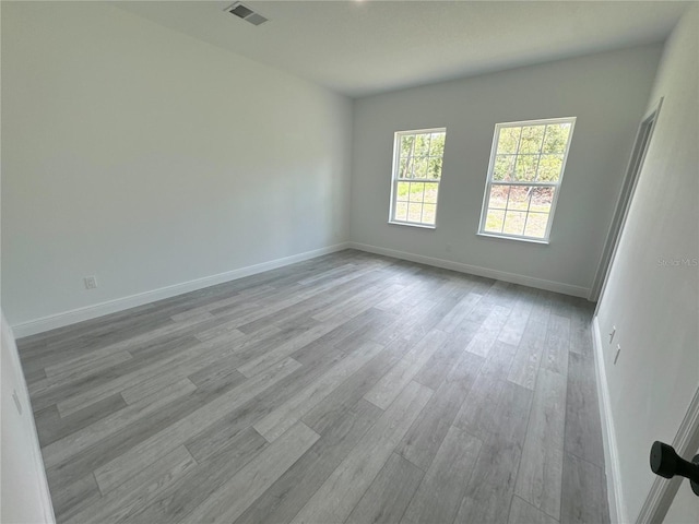 spare room with light hardwood / wood-style floors