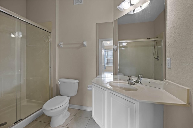 bathroom with tile patterned floors, toilet, vanity, and a shower with shower door