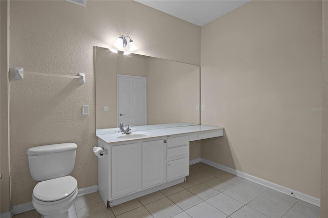 bathroom with tile patterned flooring, vanity, and toilet