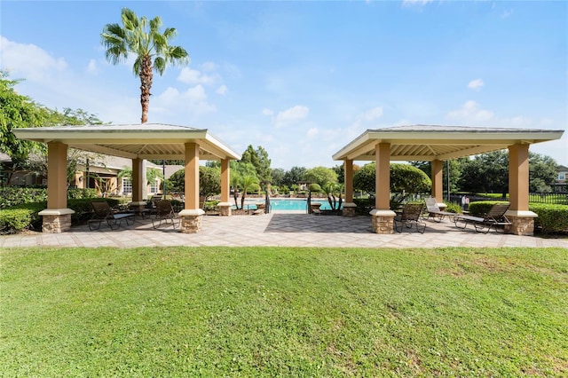 view of community featuring a swimming pool, a yard, and a gazebo