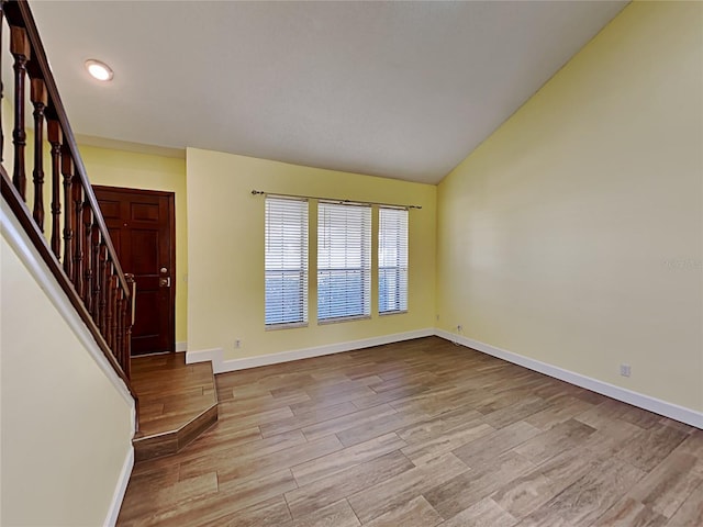 entryway featuring light hardwood / wood-style flooring and vaulted ceiling