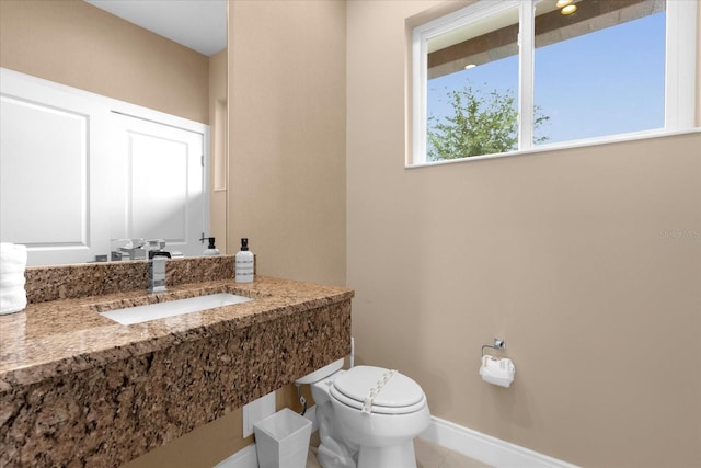 bathroom with sink, tile patterned flooring, and toilet