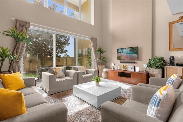 living room featuring plenty of natural light and a towering ceiling