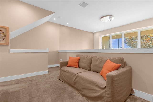 living room featuring light colored carpet and vaulted ceiling