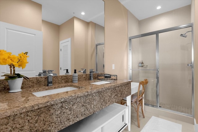 bathroom with tile patterned floors, vanity, and an enclosed shower