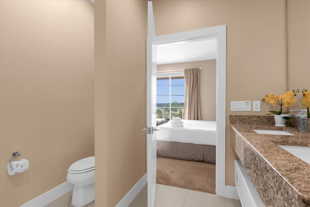 bathroom with toilet and tile patterned floors