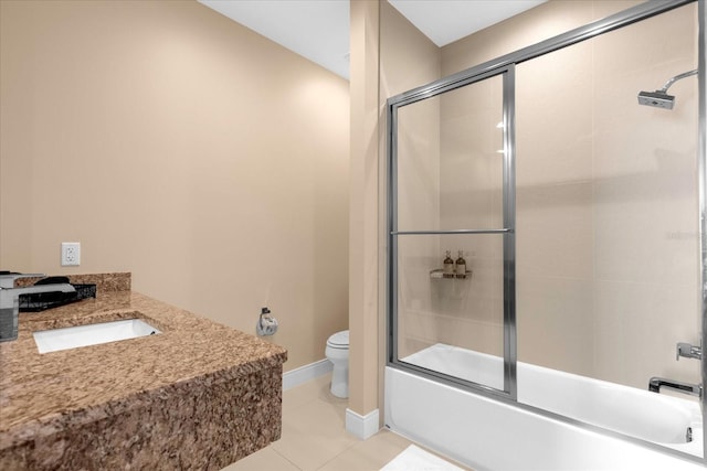 full bathroom featuring tile patterned floors, shower / bath combination with glass door, vanity, and toilet