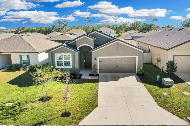 single story home featuring a front lawn and a garage