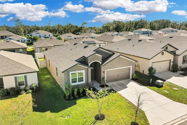 view of front of house featuring a garage and a front lawn