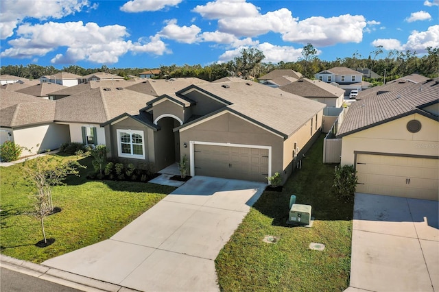 ranch-style house with a garage and a front lawn