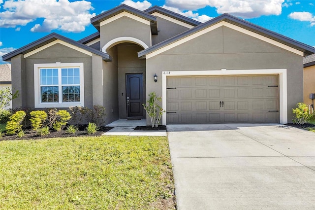 view of front of home with a garage and a front yard