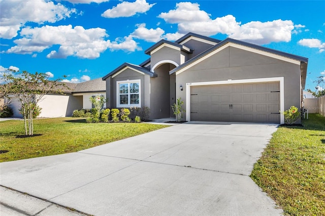 ranch-style house with a garage and a front lawn