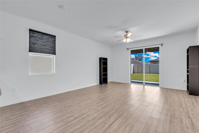 unfurnished room with light hardwood / wood-style flooring and ceiling fan