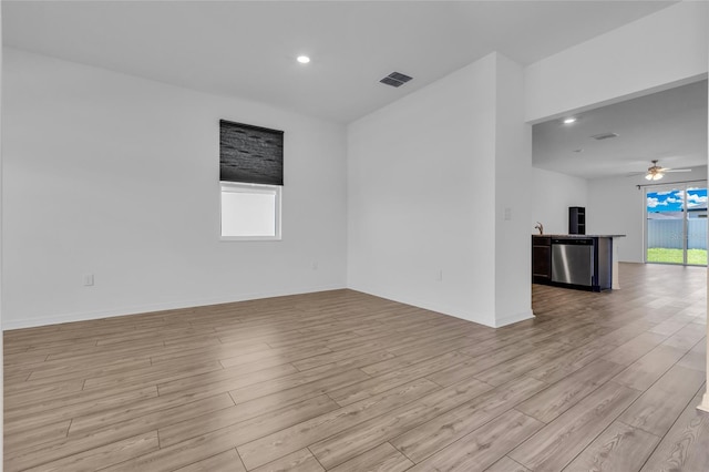 spare room featuring ceiling fan and light hardwood / wood-style floors