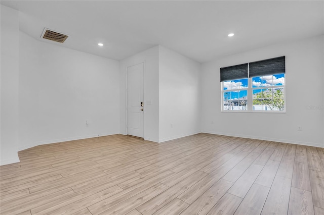 unfurnished room with light hardwood / wood-style floors