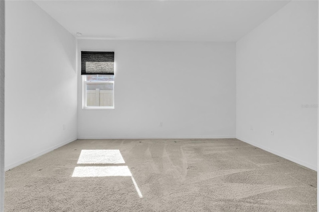 unfurnished room with light colored carpet