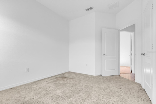 unfurnished room featuring light colored carpet