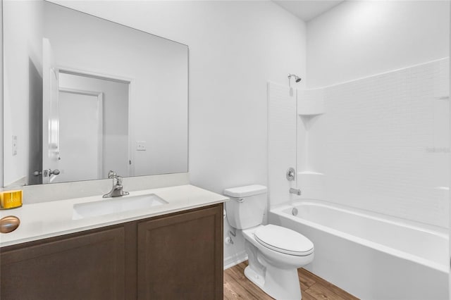 full bathroom featuring shower / bathing tub combination, hardwood / wood-style floors, vanity, and toilet