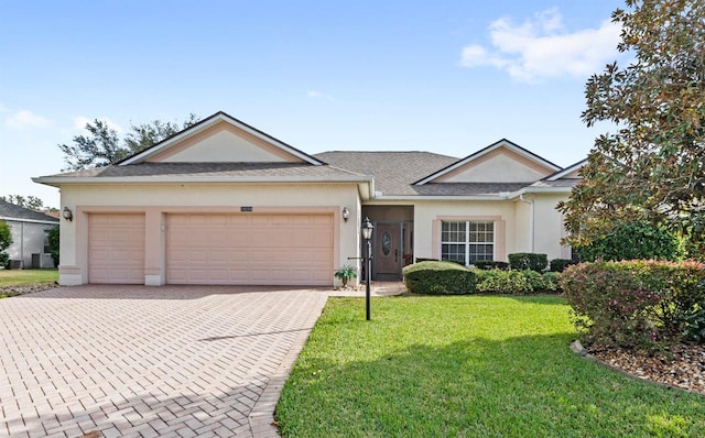 ranch-style house featuring a garage and a front lawn