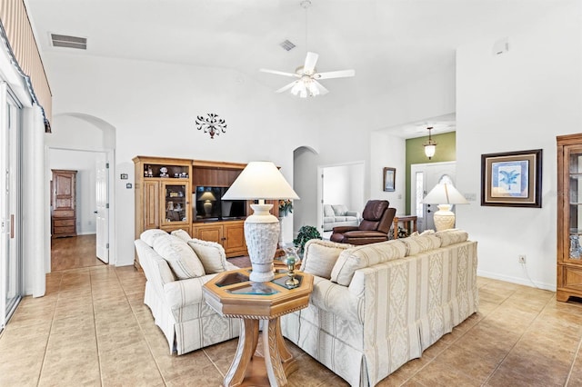 living room featuring ceiling fan, light tile patterned floors, and high vaulted ceiling