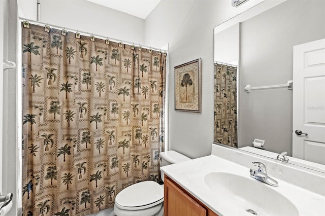 bathroom featuring a shower with shower curtain, vanity, and toilet