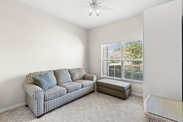 carpeted living room featuring ceiling fan