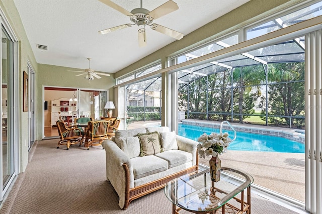 sunroom / solarium with ceiling fan, plenty of natural light, and a pool