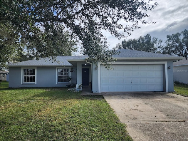 single story home with driveway, a front yard, and stucco siding