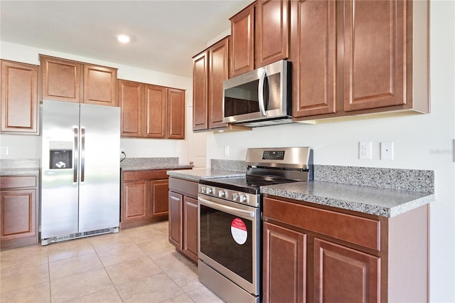 kitchen featuring appliances with stainless steel finishes and light tile patterned floors