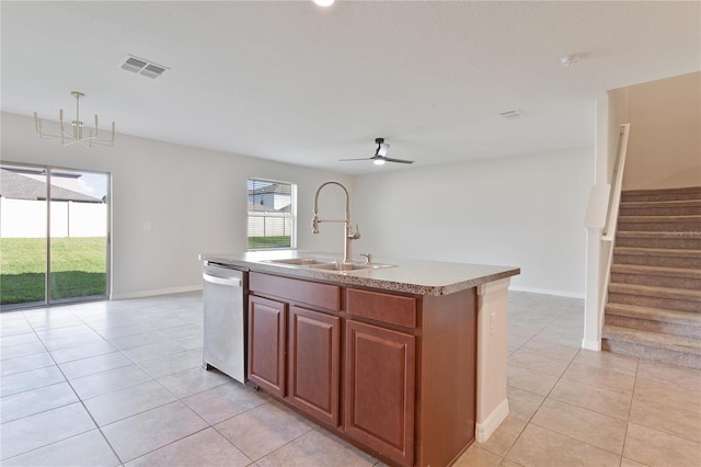 kitchen with an island with sink, stainless steel dishwasher, light tile patterned floors, and sink