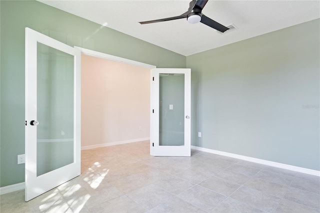 tiled empty room with french doors and ceiling fan